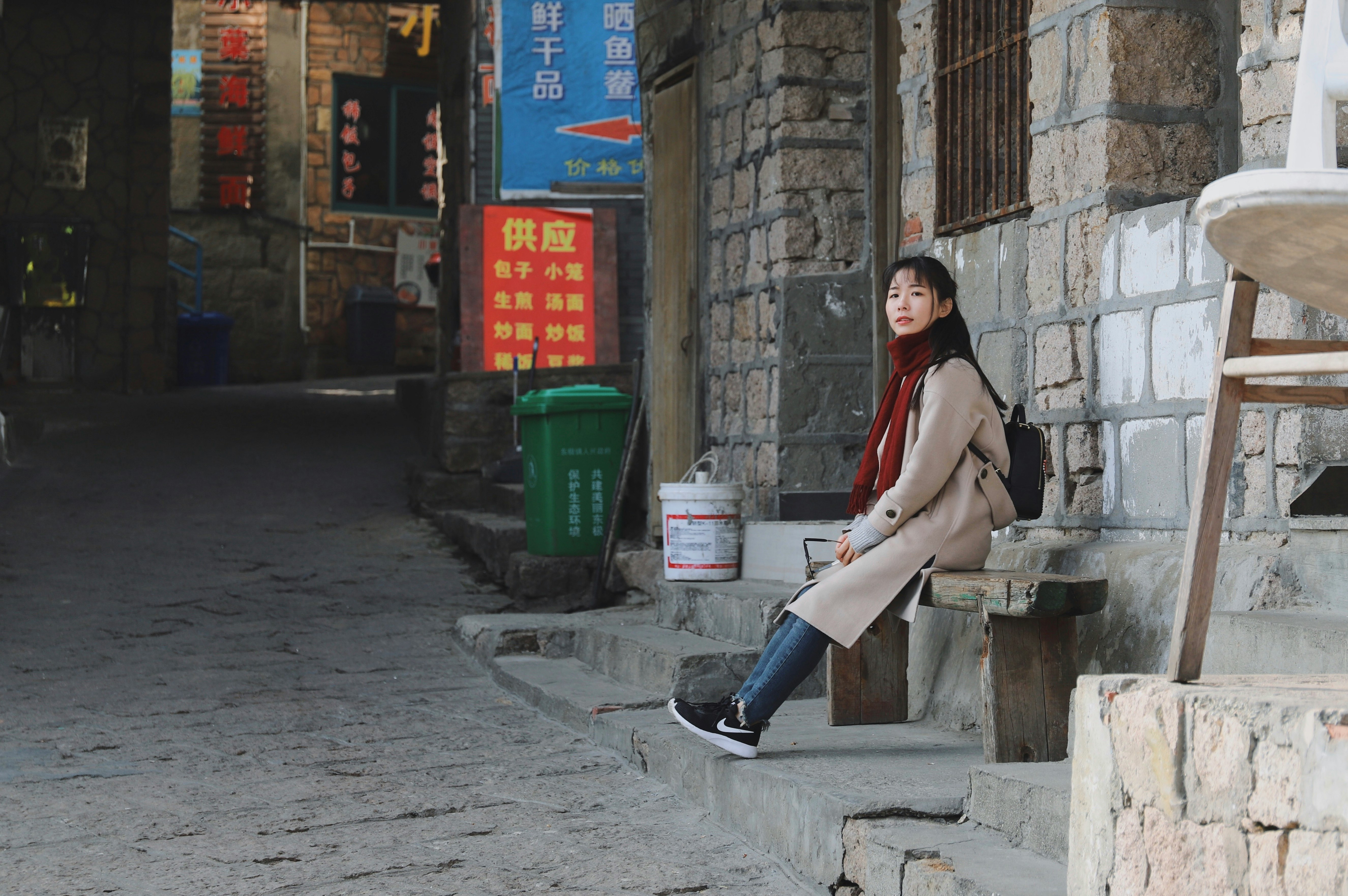 woman sitting on wood bench